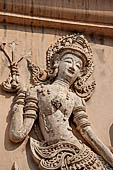 Chiang Mai - The Wat Phra Singh temple. The ho trai (temple library). The stucco figures in high relief of the base showing dancing Devas. 